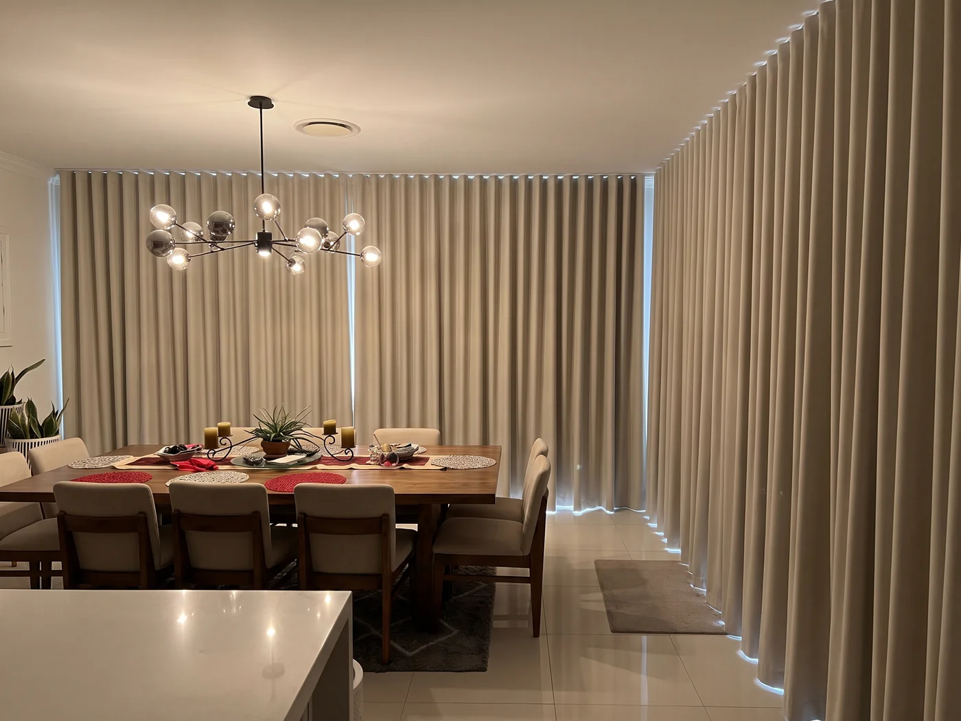 The same Sydney dining room with blockout curtains closed &mdash; daylight and the garden view completely blocked