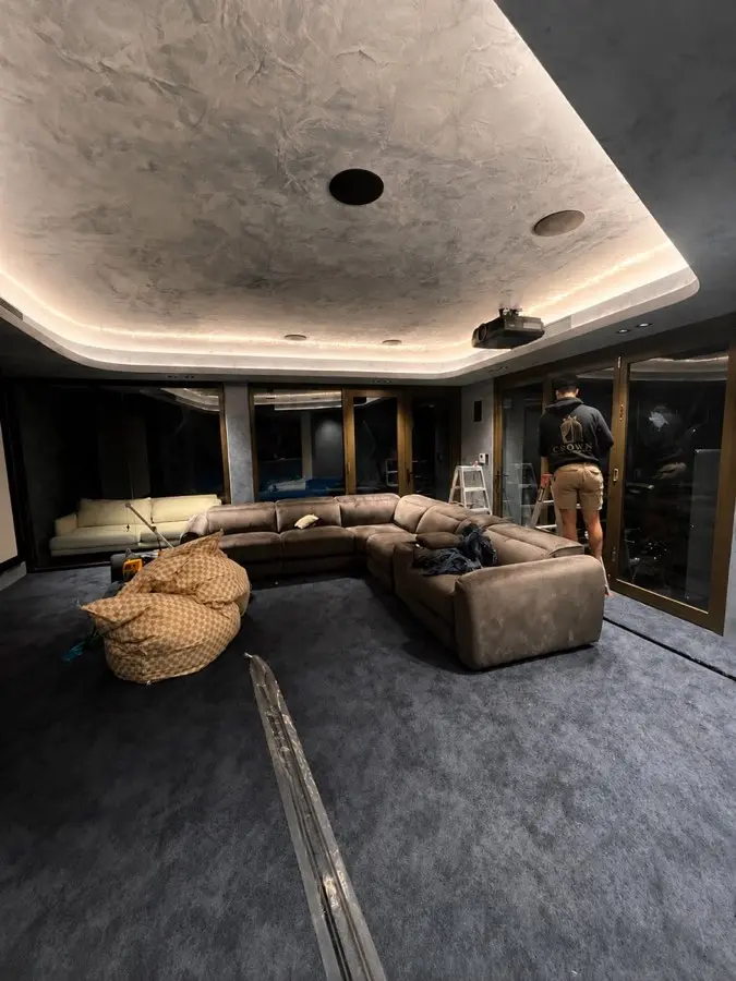 Before — home media room with bare glass walls awaiting curtains